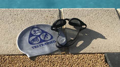 Tri-Trained swim hats sitting by the pool side
