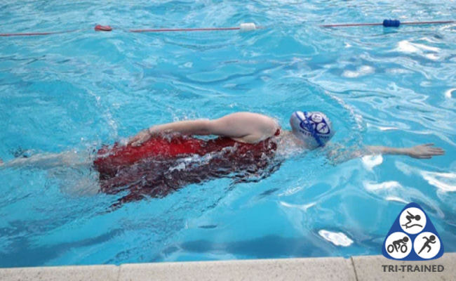 Swimmer performing a side kick swim drill in Sudbury with Tri-Trained